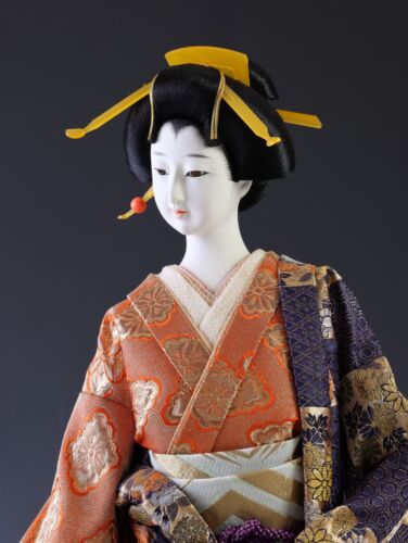 Japanese Traditional Geisha Doll with Vintage Charm Kimono and Fan Collectible.